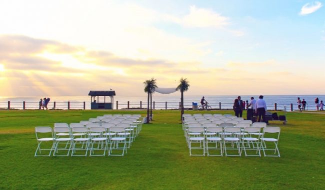 https://www.californiabeaches.com/wp-content/uploads/2017/02/California-Beach-Wedding-next-to-beach-with-sunset-and-chairs2-650x381.jpg