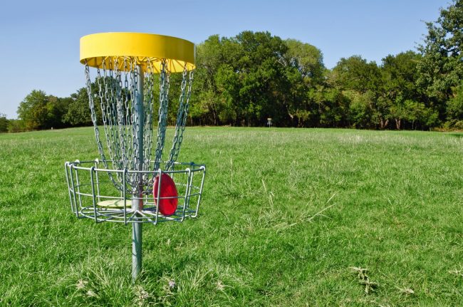 Disc golf basket hole at a park